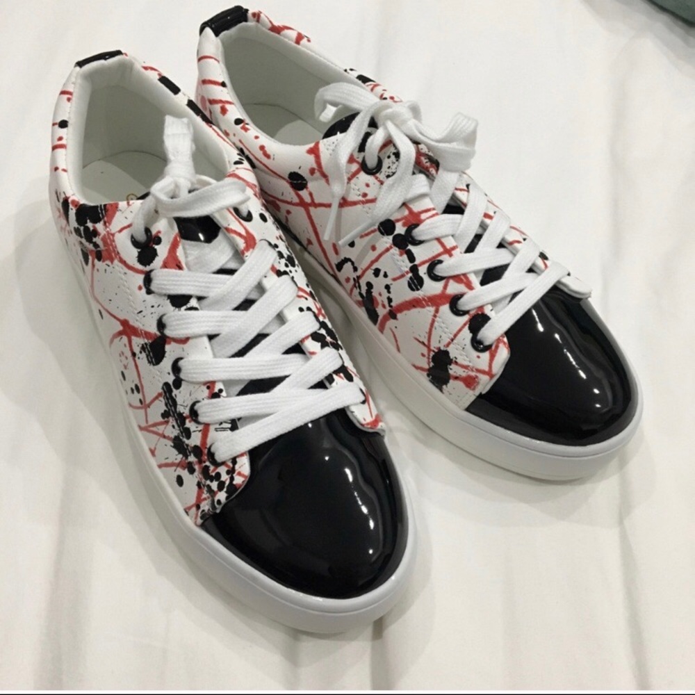 Spattered black, white and red platform sneakers.